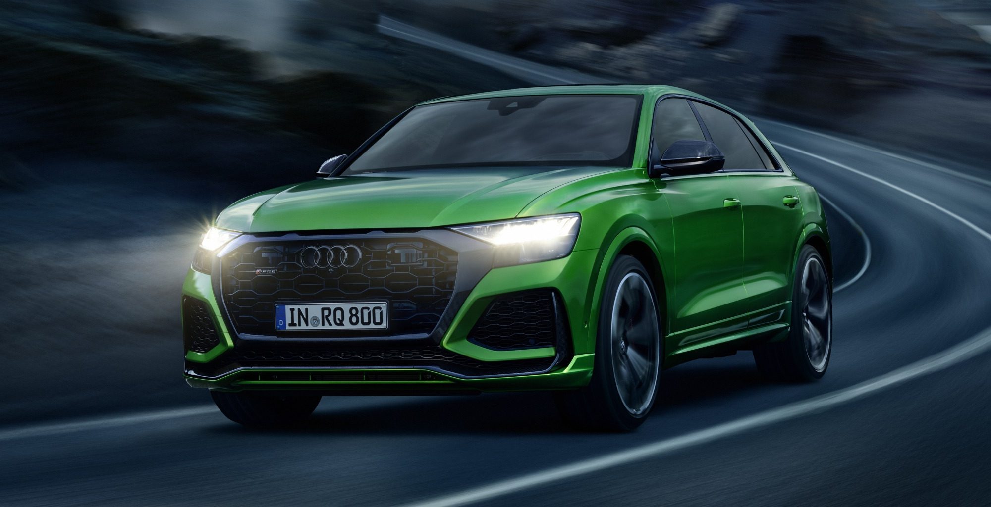 Green Audi RS Q8 driving at night time