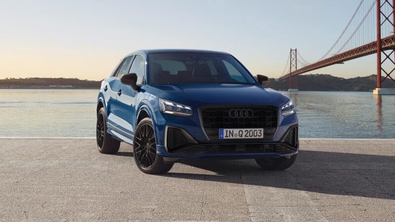 Blue Audi Q2 with a coastal view of blue water