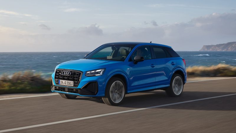 Blue Audi Q2 with a coastal view of blue water