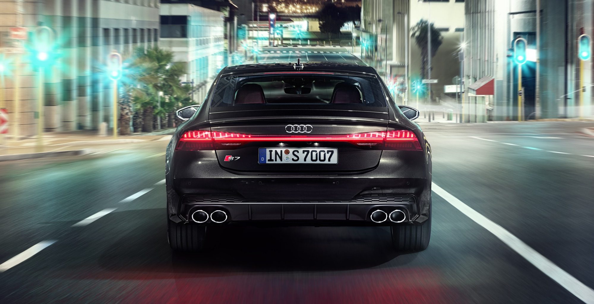 Black Audi S7 Sportback driving in the city at night time