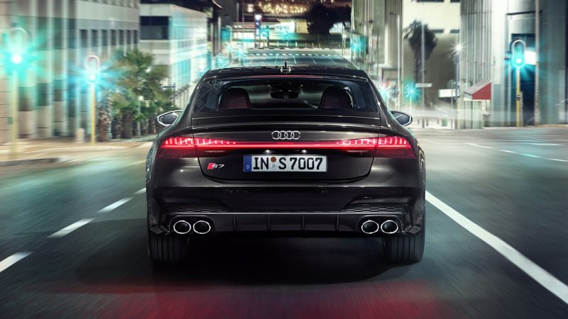 Black Audi S7 Sportback driving in the city at night time