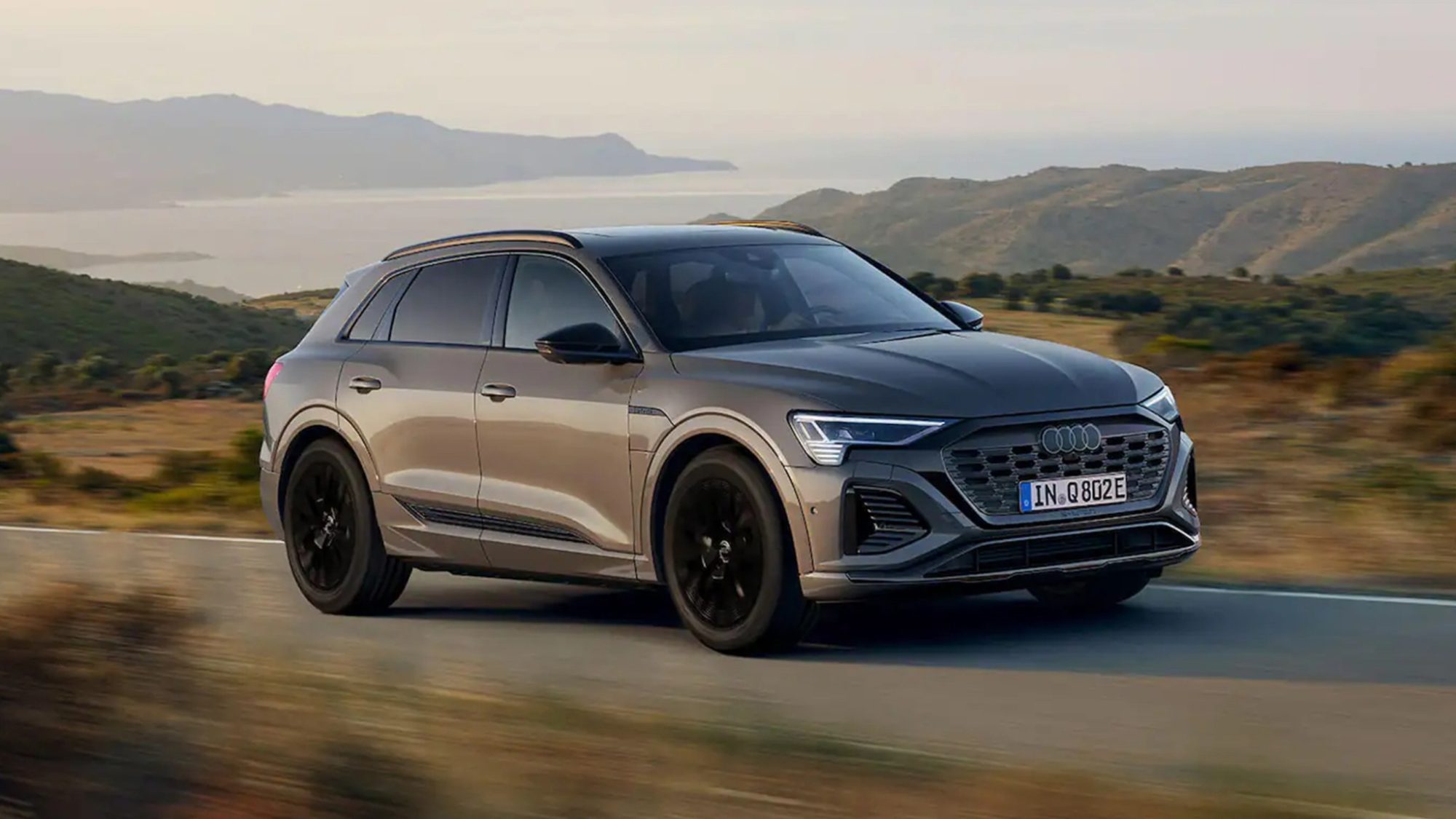 Grey Audi Q8 e-tron driving in the country side